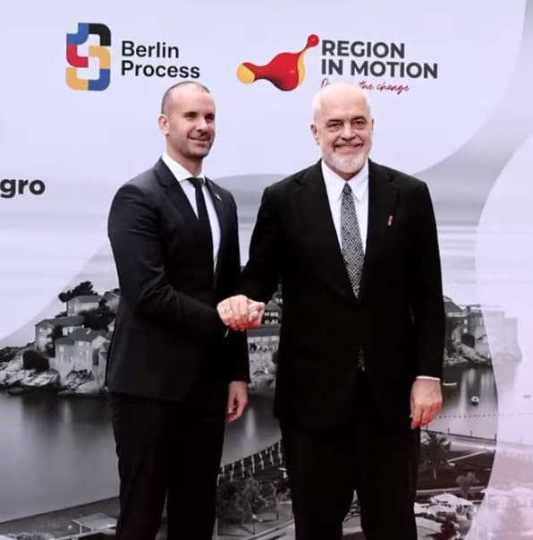 Prime Minister Edi Rama shakes hands with Montenegrin Prime Minister Milojko Spajić in front of a Berlin Process backdrop